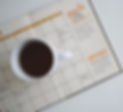 white%20ceramic%20mug%20with%20coffee%20on%20top%20of%20a%20planner_edited.jpg