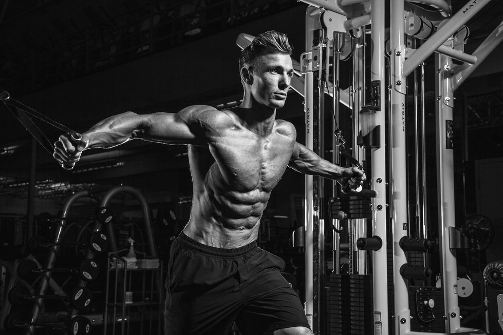 IFBB pro Mike Sheffer exercising on gym equipment, black and white photo.