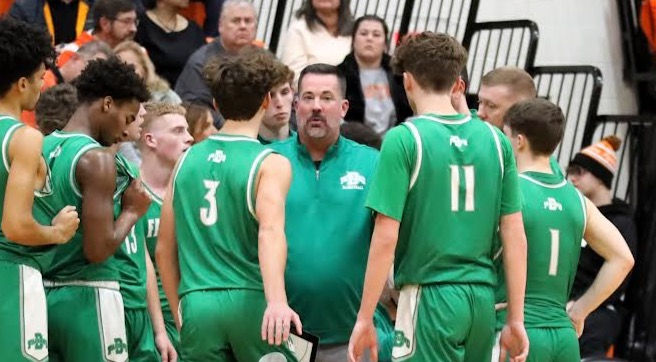 Fairland head coach Nathan Speed (middle) talks to his team during a timeout.