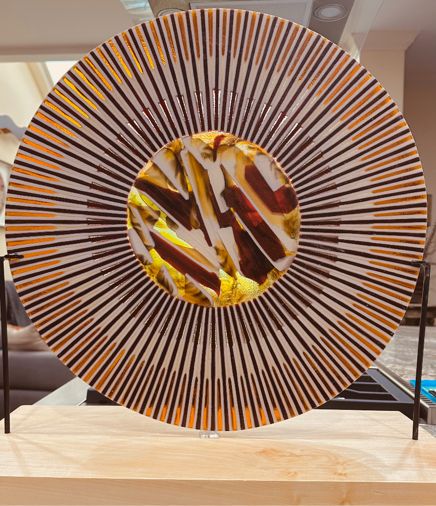 A sphere of colored glass, yellow and gold representing a sun