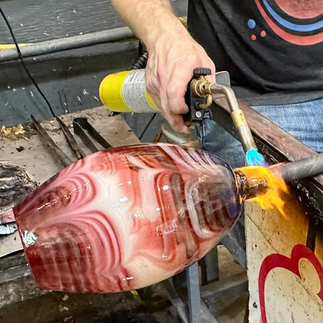 Red and White combed glass being torched off
