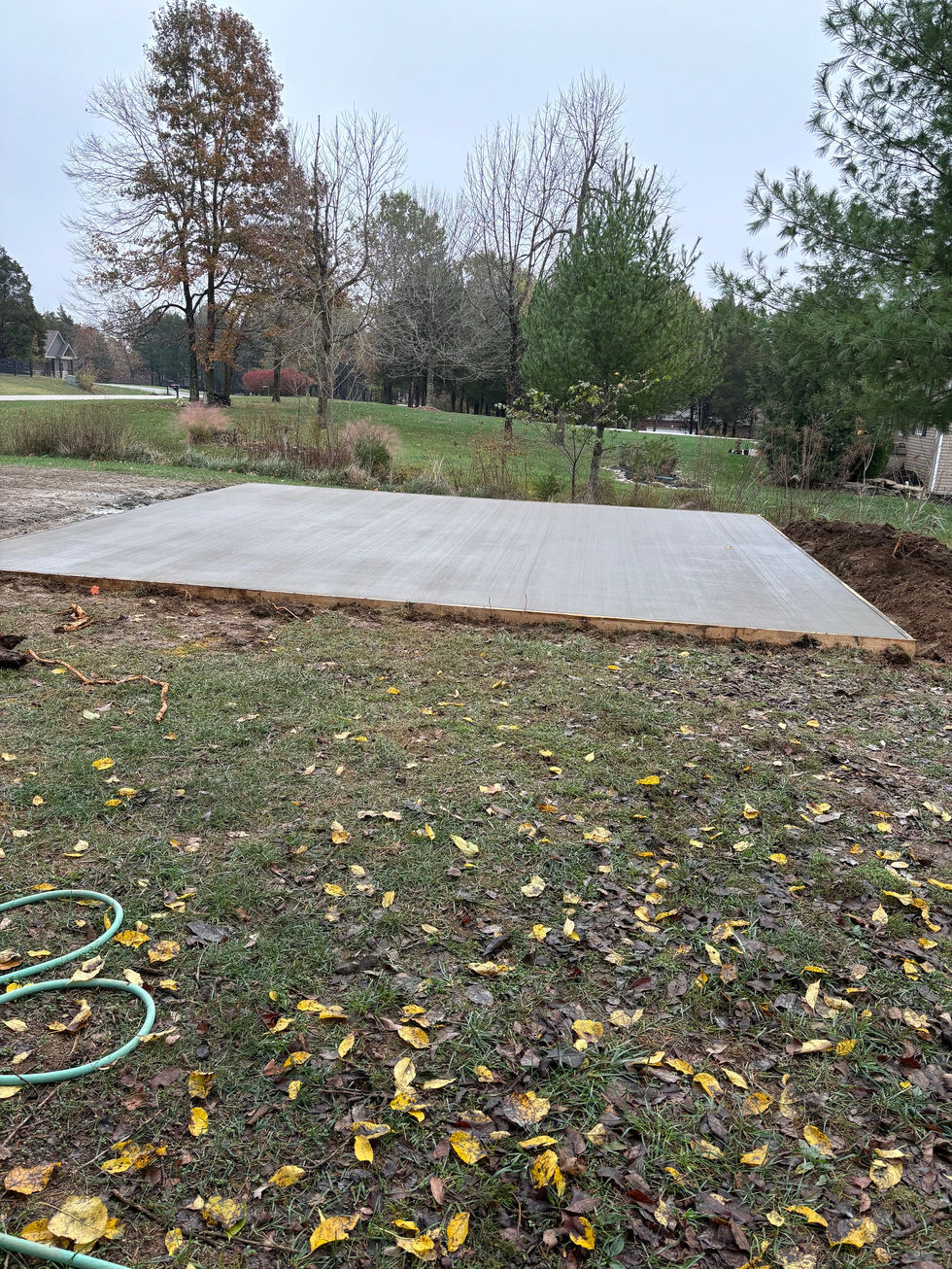 Concrete car port pad with a brush finish completed gravel driveway in Taylorsville, KY