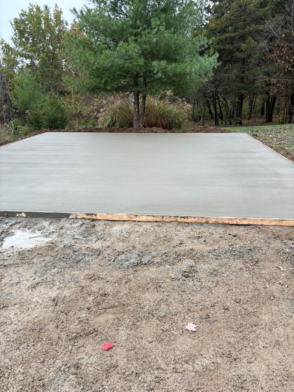 Concrete car port pad with a brush finish completed gravel driveway in Taylorsville, KY