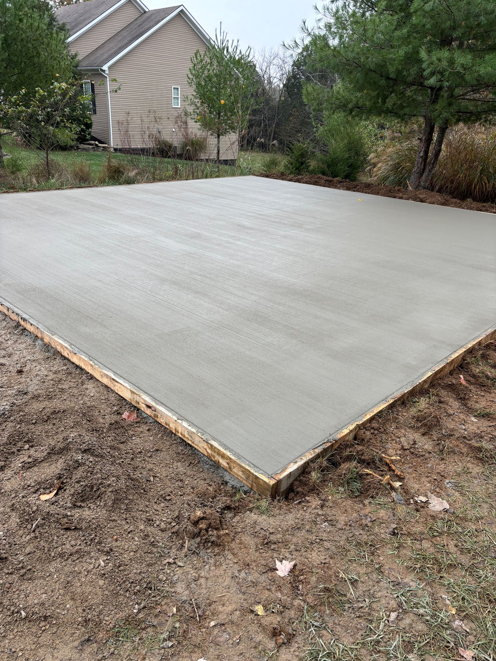 Concrete car port pad with a brush finish completed gravel driveway in Taylorsville, KY