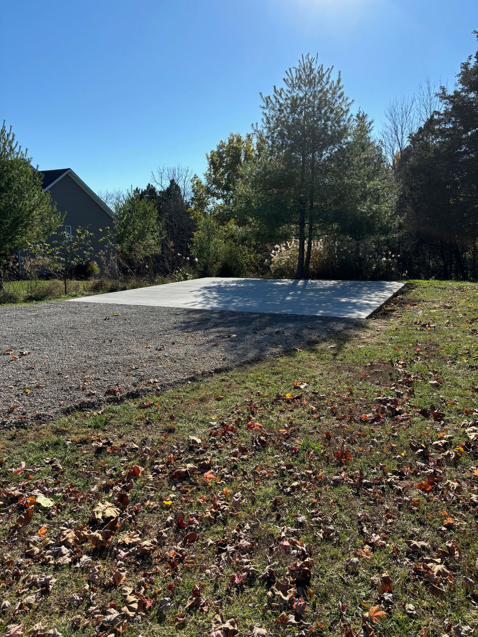Concrete car port pad with a brush finish completed gravel driveway in Taylorsville, KY