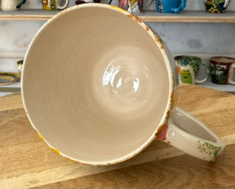 Thumbnail: Large ceramic mug interior empty, bright with a handle, on wooden board