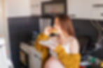 Pregnant woman enjoying a sandwich in a kitchen
