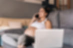 Smiling pregnant woman talking on the phone