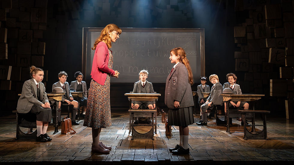 Eve Norris (Miss Honey), Carla Lopez Corpas (Matilda) and the company of Matilda - The Musical at the Cambridge Theatre, London (Helen Maybanks)
