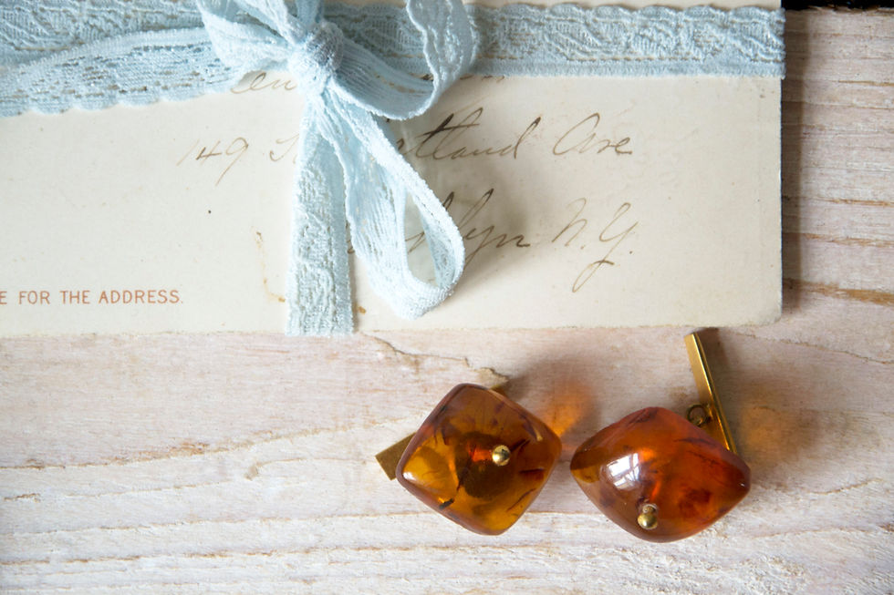 Vintage amber metal cuff links with warm tones and decorative character