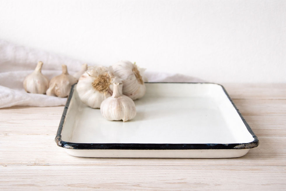 Vintage white enamel tray with black rim and shallow metal form