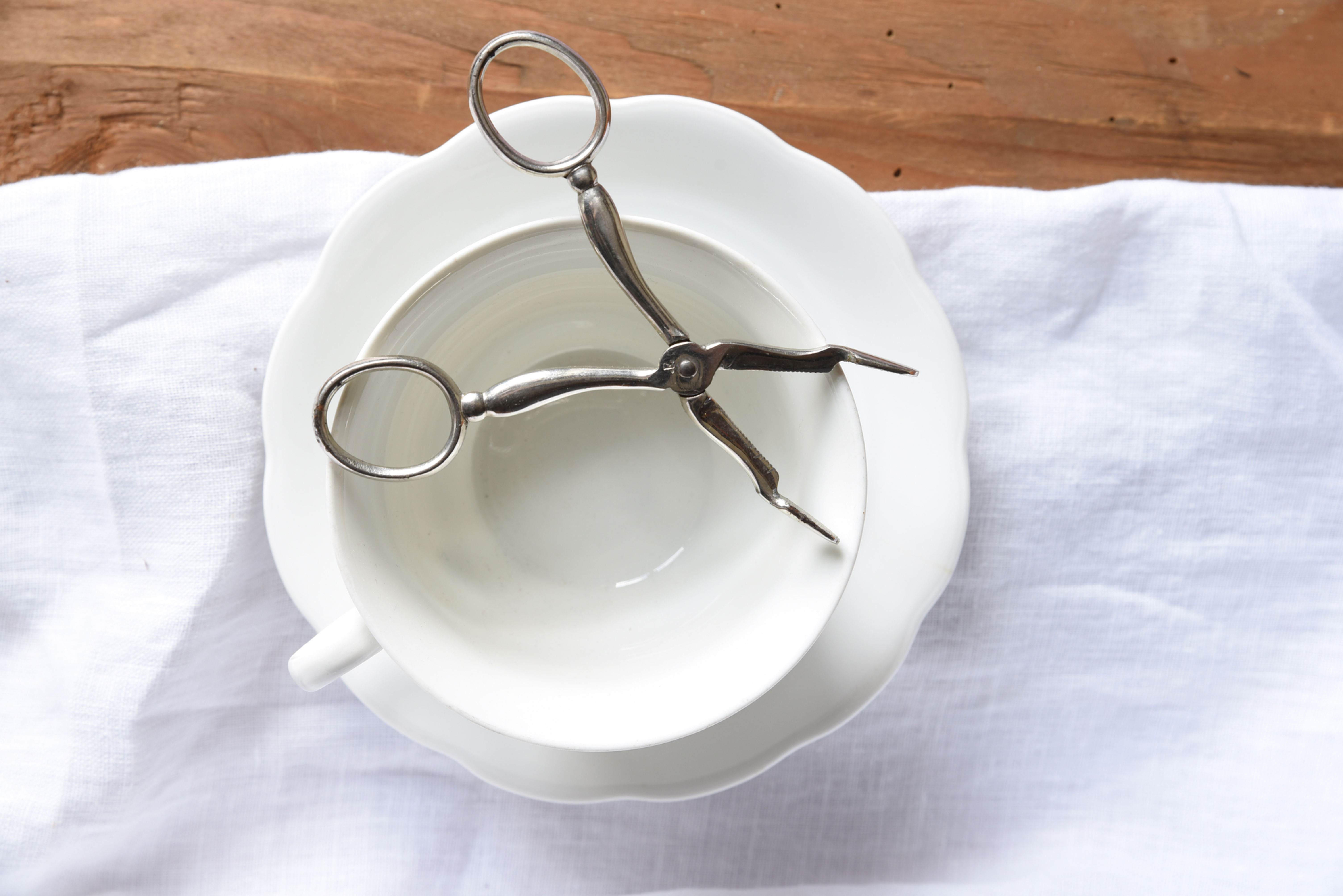 Vintage silver tone sugar tongs with glossy metal finish