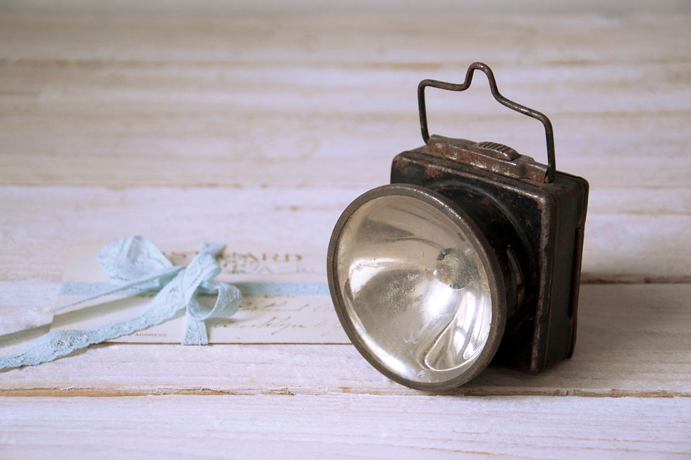 Industrial vintage flashlight featuring metal body and glass details