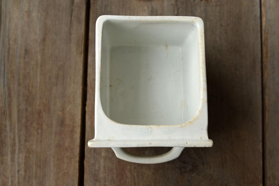Vintage ceramic salt drawer photographed as a timeless kitchen accessory with authentic signs of age