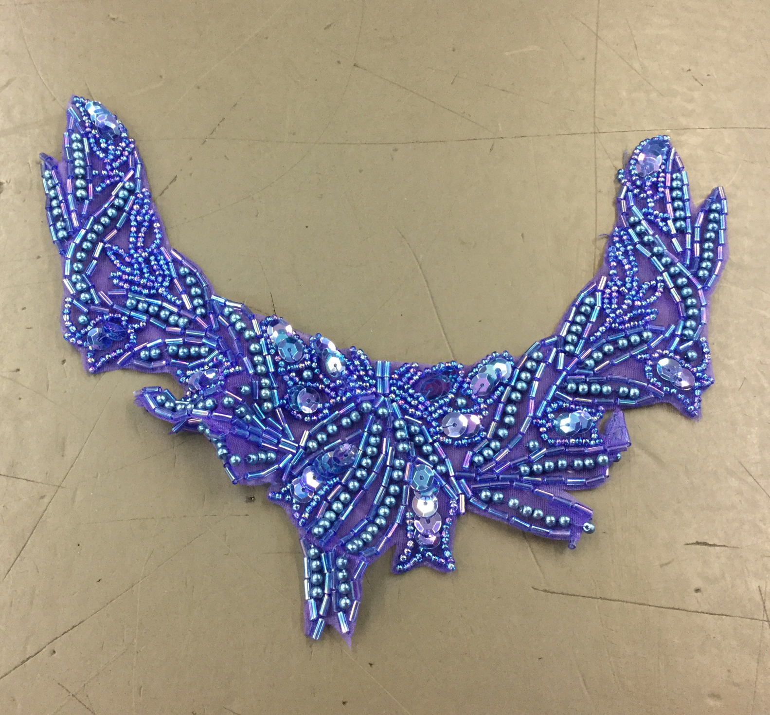 Neon purple appliqué with beading & sequins.