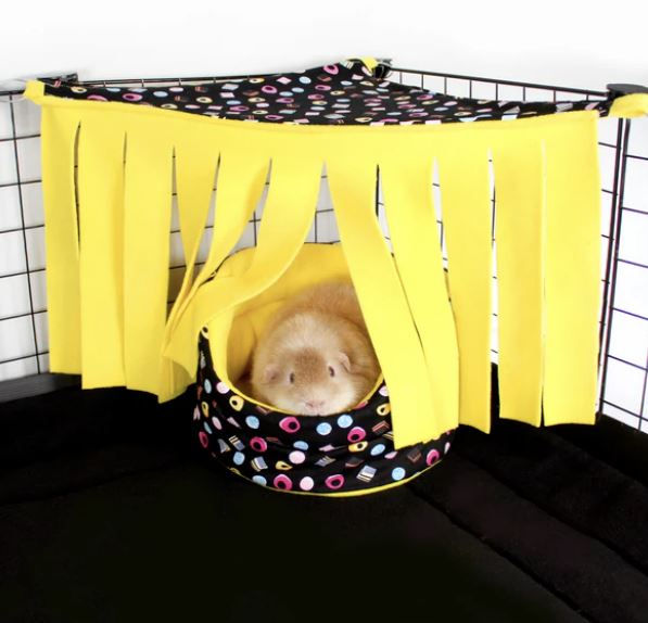 Guinea pig enjoying his fleece bed in a fleece forest