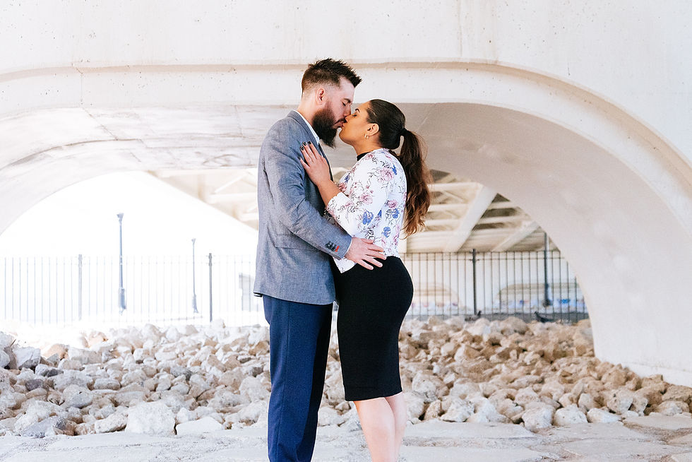 Man and woman kiss underneath bridge near Ohio City, Cleveland, Ohio