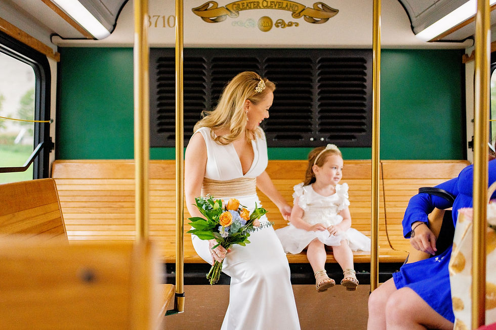 little girl and bride ride the trolly on way to the wedding in cleveland