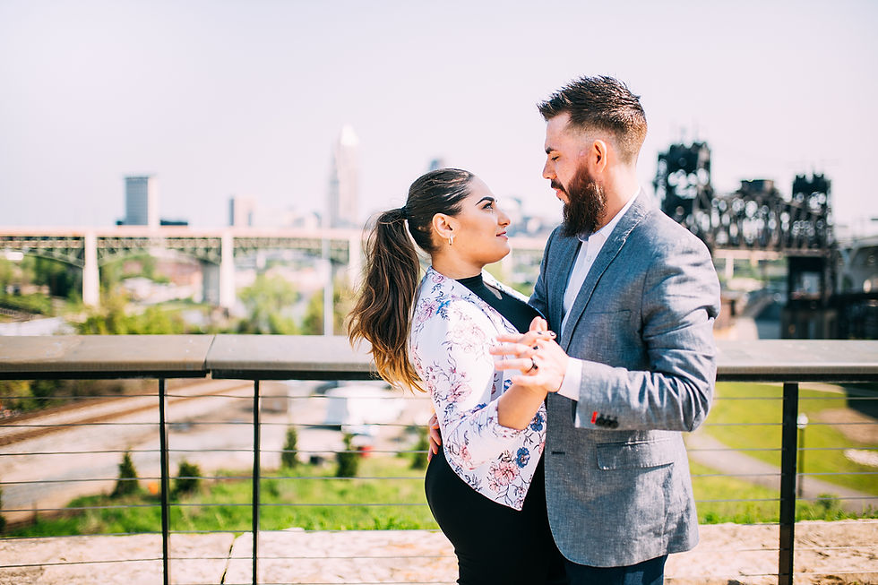 Woman and man hold hands and look into each other's eyes in Cleveland Ohio