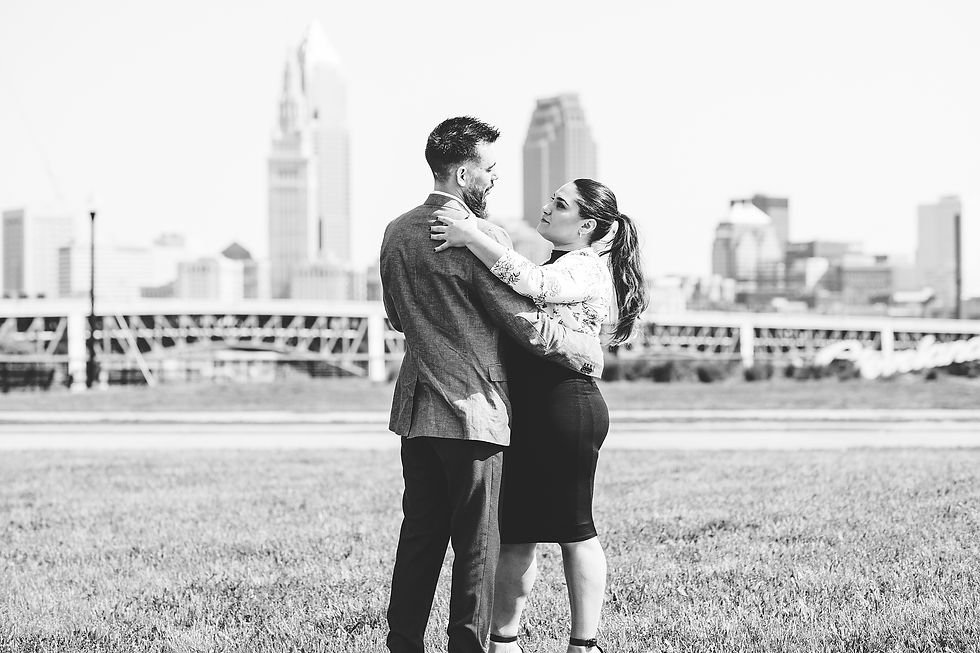 Man and woman dance together in front of the Cleveland, Ohio skyline