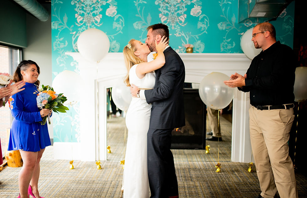 bride and groom kiss during wedding ceremony at punch bowl social, cleveland ohio