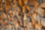 Lots of chopped firewood on a pile close up. Harvesting firewood for the winter. Dry firew