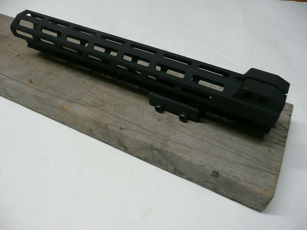 Thumbnail: AR15 Barrel shroud mounted to a flat wood board with an adapter