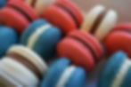 Red, white and blue macarons displaying delicate, neat feet