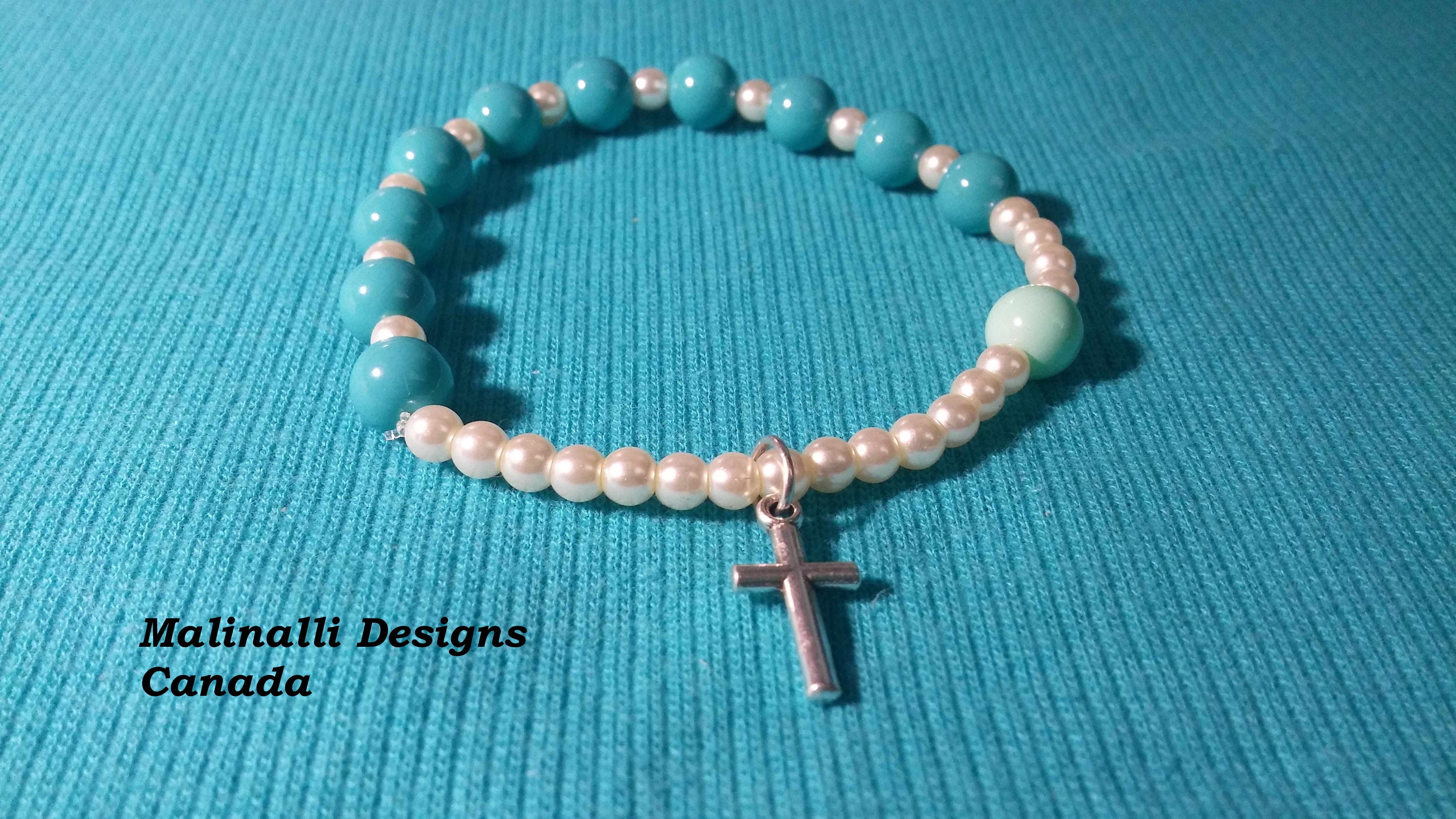 014 Light blue and pearls with silver cross.