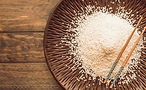 white-rice-grains-chopsticks-tray-wooden-backdrop.jpg