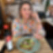 Emmylou presenting a plate of Avocado and Chorizo Bruschetta with toasted bread, smashed avocado, spicy chorizo and fresh herbs.