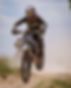 Dirt bike races through the Utah desert with a dirt bike that has been race-tuned by Alpin