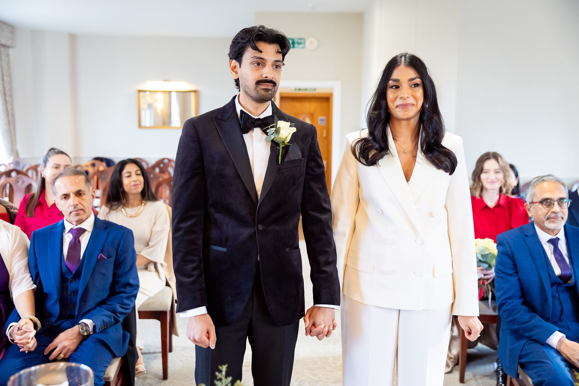Bride and groom holding hands during their vows