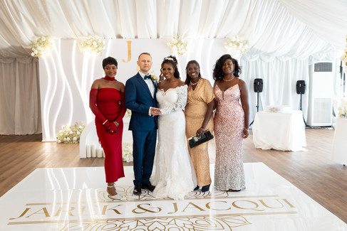 Bride and groom walking together inside marquee