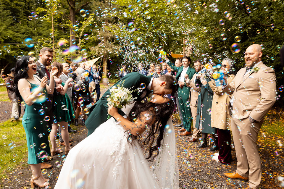 Couple kissing amid bubbles at Nomadic Dinners, photographed by a Hertfordshire and London wedding photographer