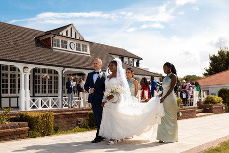 Wide group photo outside London Shenley Club after wedding ceremony