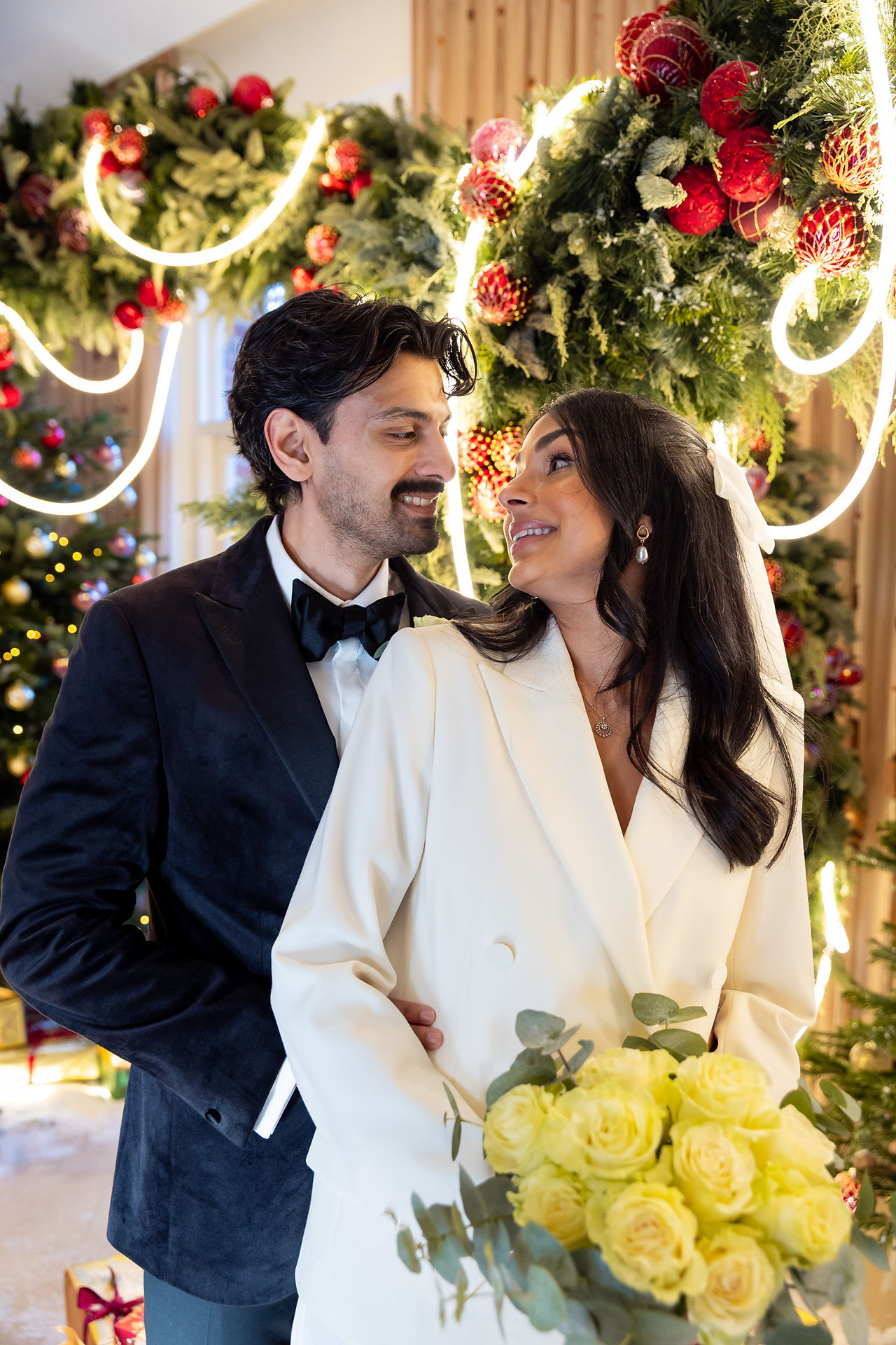 Winter couple portraits at The Grove Hotel captured naturally by Hektor Lleshi Photography by Christmas tree