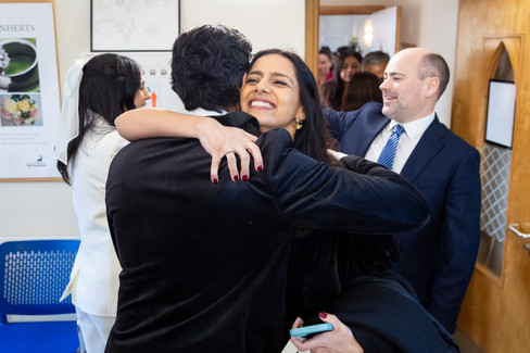 Guests hugging the bride and groom after the ceremony Hertfordshire wedding 