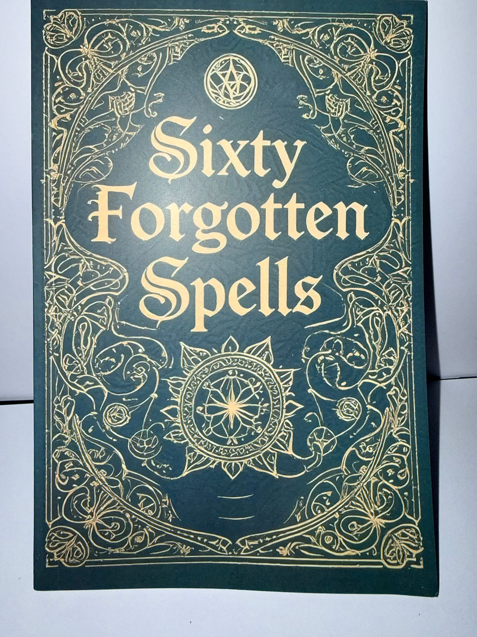 Sixty Forgotten Spells book cover, green and gold