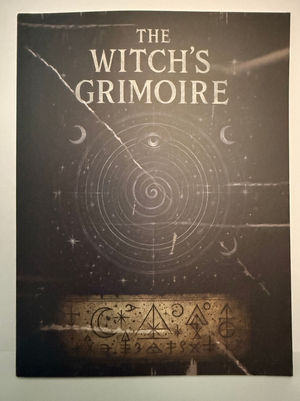 The Witch's Grimoire book cover with celestial symbols