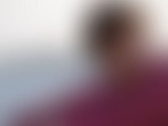 Young person in a red hoodie laughing on a beach with blurred background. Bright mood. "Prime Video" logo in the corner.