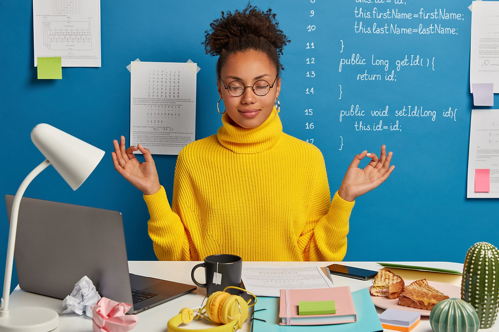woman-freelance-worker-does-yoga-exersice-workplace-enjoys-calm-tranquil-atmosphere-wears-
