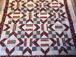 Customers quilt it’s graduation season...quilting is swirls and flames in gray thread to match the b