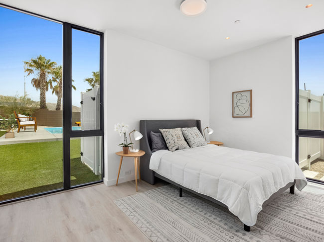 Master bedroom in the main home of Scenic Crest Villas with large windows and natural light.