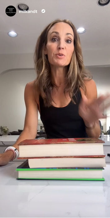 A woman gestures while speaking to her camera for a social media story taken from her home.