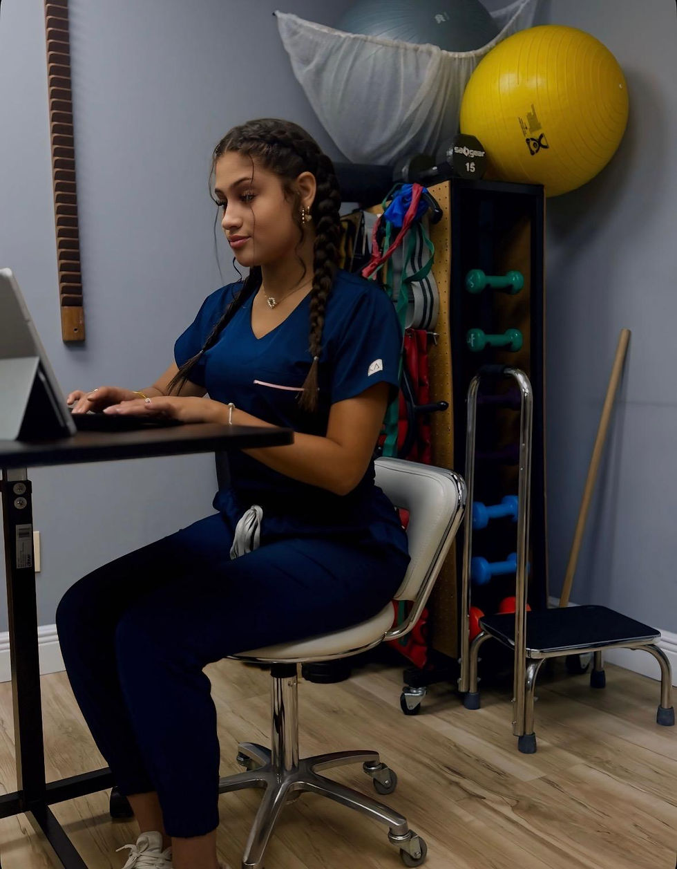 a picture of a chiropractic assistant helping patients with pain to feel their best with top chiropractic care