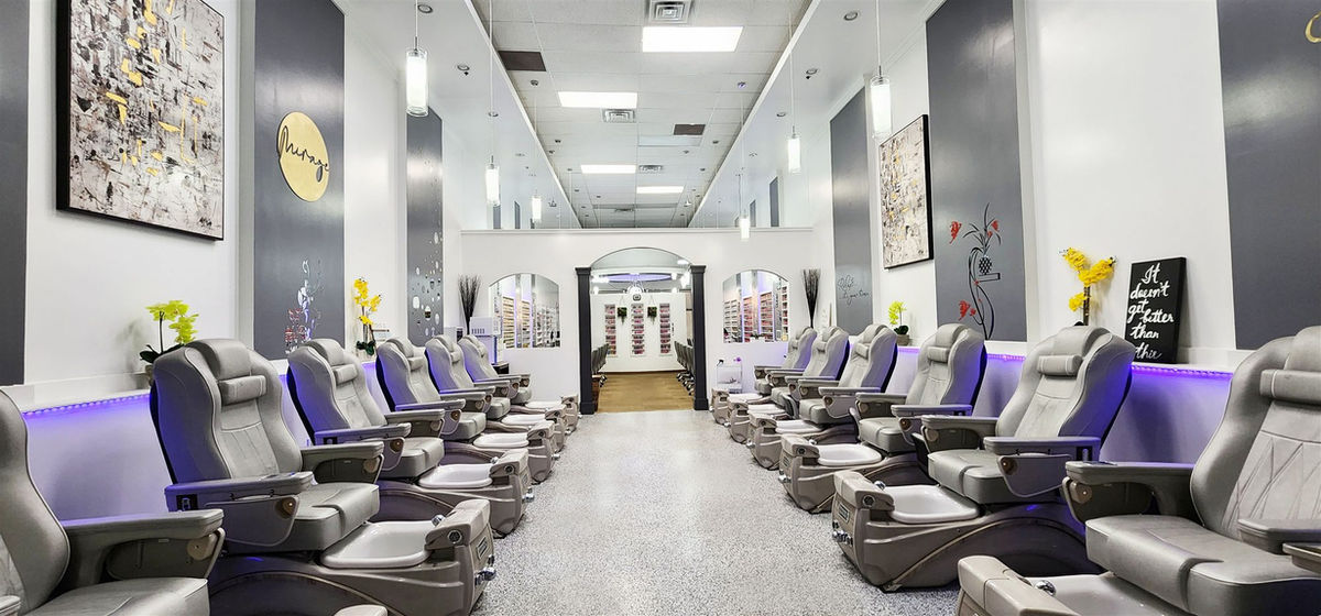 The pedicure room at Mirage Nails & Spa, chairs along both walls