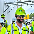 Tour guide at Waste Management gives tour with wireless mic and headphones.