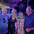 People at a backyard silent disco wearing headphones.
