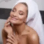 Woman with radiant skin wearing a towel